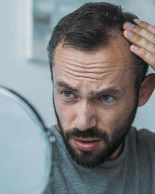 Male checking hair in mirror